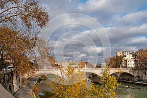 daytime winter cityscape of a bridge and tiber river in rome