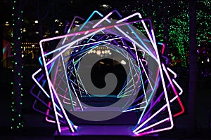 Dazzling neon display of rotating squares illuminates the night sky