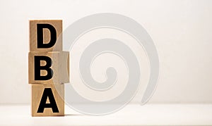 DBA - acronym from wooden blocks with letters, DataBase Administrator or doing business as abbreviation DBA concept