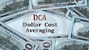 DCA - acronym on the background of cash dollar bills