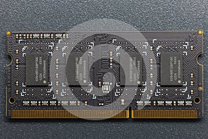 DDR SODIMM memory module. Close-up of an electronic circuit board with gold-plated contacts and memory chips