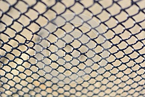 De focused Metal net rust. Abstract background, chain-link fencing. Rusty chain link.
