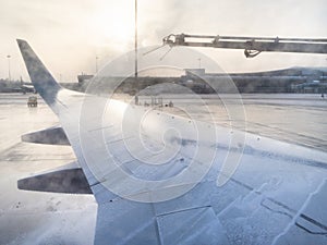 De-icing of aircraft wing by chemicals in airport