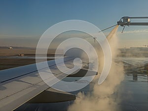 De-icing airplane wing before take off