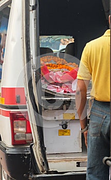 The dead body of an elderly Indian woman is delivered by ambulance at Swargadwar crematorium in Puri,Odisha state, India