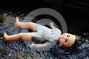 Dead doll floating in water