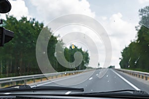 Dead insects on the windshield of the car. Flattened beetles on the surface of the glass