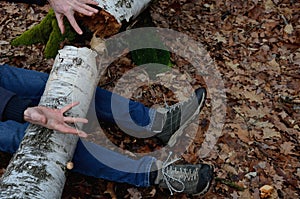 Dead man covered with a tree. the tree turned upside down and injured itself, falling while walking on a hiker, a forest worker. l