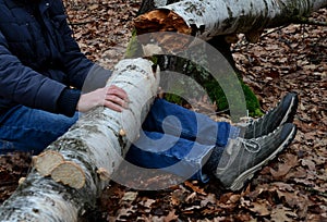 Dead man covered with a tree. the tree turned upside down and injured itself, falling while walking on a hiker, a forest worker. l