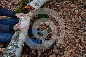 Dead man covered with a tree. the tree turned upside down and injured itself, falling while walking on a hiker, a forest worker. l