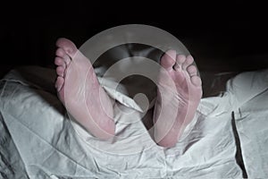 Dead man lying on the floor under white cloth - retro style