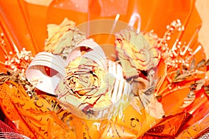 Dead rose on orange background