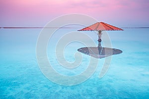Dead Sea beach. Sun umbrella in water