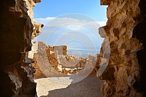 The Dead Sea and desert view through arch in Masada fortress, Israel