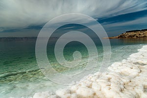 Dead Sea salt sediments against thunder sky