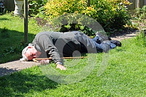 Dead or unconscious elderly man lying down.