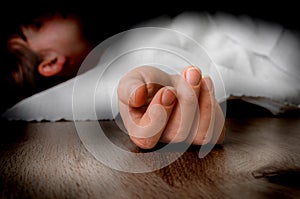 Dead woman lying on the floor under white cloth