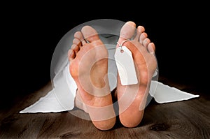 Dead woman lying on the floor under white cloth