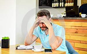 Deadline coming search ideas need inspiration. Man disappointed desperate face sit cafe with mug of coffee and notepad