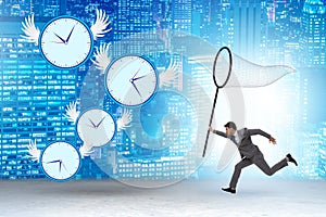 Deadline concept with businessman catching clocks