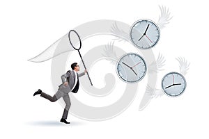 Deadline concept with businessman catching clocks