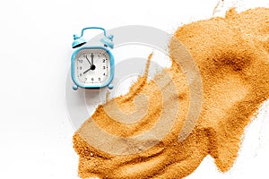 Deadline concept. Clock near sand on white background top-down