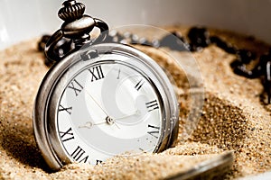 Deadline concept pocket watch in sand background