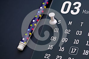 Deadline concept with push pin on calendar date.