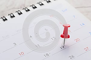 Deadline concept with push pin on calendar date close up