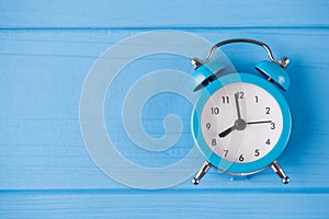 Deadline concept. Top above overhead view close-up photo of blue clock isolated on blue wooden background with copyspace