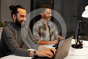 Creative team with computer working late at office