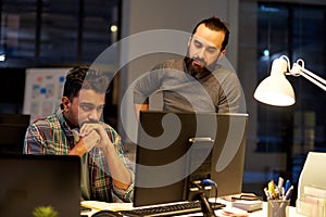 Creative team with computer working late at office