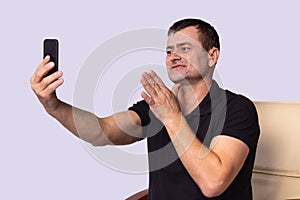 Deaf adult man using hearing aid to communicate freely with relatives on a video call and feel himself joyful.