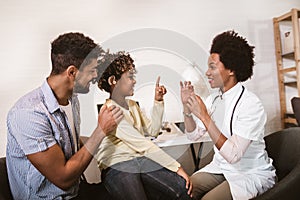 Deaf african american girl with ear implant at doctor`s office