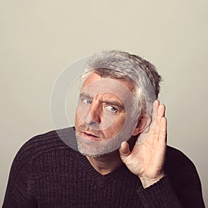 Deaf aged man listens