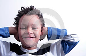 Deaf boy covering his ears stock photo