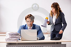 The deaf employee using hearing aid talking to boss