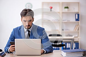 Deaf male employee using hearing aid at workplace