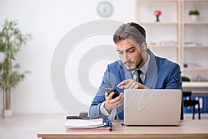 Deaf male employee using hearing aid at workplace