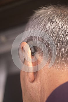 Deaf man hearing aid ear