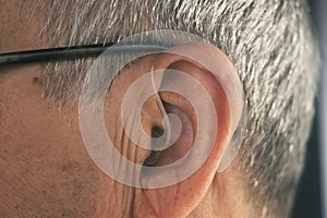 Deaf man hearing aid ear