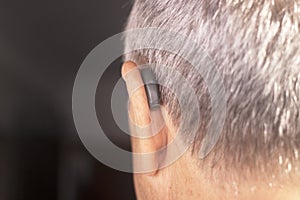 Deaf man hearing aid ear