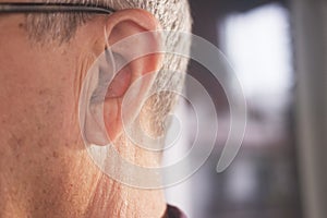 Deaf man hearing aid ear