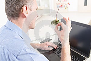 Deaf man using sign language with laptop