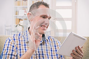 Deaf man using sign language on the tablet