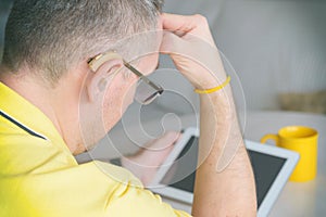 Deaf man using sign language on the tablet