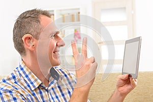 Deaf man using sign language on the tablet