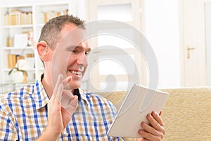 Deaf man using sign language on the tablet