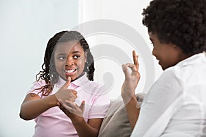 Deaf Mother Talking Sign Language With Her Daughter