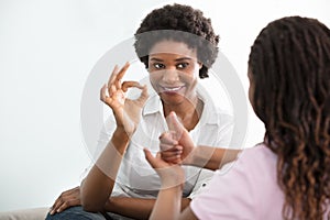 Deaf Mother Talking Sign Language With Her Daughter